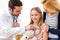 Doctor listening heart beatment of little girl