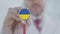 Doctor listening with the stethoscope with flag of Ukraine. Ukrainian healthcare