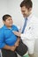 Doctor Listening To Boy\'s Heartbeat