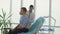 A Doctor Listens to Lungs with a Stethoscope To a Young Man in AaClinic Office.