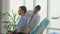 A Doctor Listens to Lungs with a Stethoscope To a Young Man in AaClinic Office.