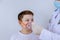 Doctor looking at child patient inhaling through oxygen mask