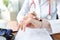 Doctor looks at clock at work table in medical office