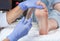 The doctor makes intramuscular injections of botulinum toxinon the feet