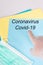 Doctor man finger pointing Coronavirus written on blue folder paperwork covid-19