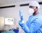Doctor, man and surgery, put glove on hand and start operation with face mask, PPE and healthcare at hospital. Surgeon