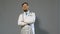 Doctor man in white coat on gray background, medicine concept