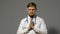 Doctor man in white coat on gray background, medicine concept