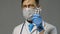 Doctor man in white coat on gray background, medicine concept