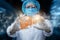 Doctor in a mask shows a model of the liver on a blurred background