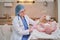 Doctor measures the growth of a newborn baby. A nurse in uniform checks the girth of the child head and abdomen