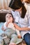 The doctor measures the temperature of the child. Call a doctor at the patients home. family pediatrician doctor family doctor at