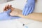 Doctor measuring pulse on patient forearm near empty syringe and medication closeup