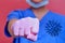 A doctor in medical gloves punches the virus, close-up. Concept of ending the coronavirus pandemic and lifting the quarantine -