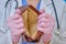 A doctor in medical gloves shows an empty wallet. Nurse in a white coat, the concept of the financial crisis due to coronavirus