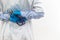 A doctor in a medical gown and blue gloves with a stethoscope in his hands in a hospital on a white background