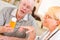 Doctor or Nurse Explaining Prescription Medicine to Attentive Senior Man