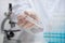 Doctor, nurse or laboratory assistant hand in protective gloves keeps biological tube with covid-19 vaccine. Healthcare And