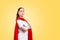 A doctor or nurse in medical gloves and a red superhero Cape on a yellow background. Copy space. Super hero power for clinic and