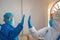 Doctor and nurse in personal protective equipment greet each other without touching hands in hospital during covid-19 or