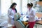 Doctor and nurse prepare female patient for dental procedure