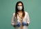 Doctor / nurse smiling behind surgeon mask. Closeup portrait of young caucasian woman model in white medical scrub