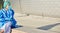 Doctor or nurse takes a break in front of a clinic in protective clothing