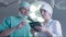 Doctor and the nurse using a tablet in the operating room