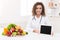 Doctor nutritionist holding blank digital tablet, mockup