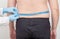 Doctor nutritionist measures the big fat belly of a male patient with a measuring tape. Weight loss and healthy