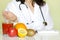 Doctor nutritionist in office with healthy fruits