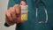 Doctor offering patient a medicine pill bottle, drug treatment