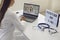 Doctor online. Female doctor listens to a sick patient using laptop video chat call sitting at the table in clinic.