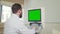 Doctor operating ultrasound scanner with green screen