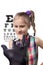 Doctor ophthalmologist gives little cute girl her new glasses