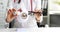 Doctor ophthalmologist holds glasses and contact lenses on background of mock-up of human eye