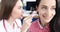 Doctor otorhinolaryngologist examining ear of woman patient with otoscope 4k movie