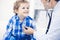 Doctor and patient child. Physician examining little boy. Regular medical visit in clinic. Medicine and health care