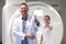 Doctor and patient are holding thumbs up in MRI room in clinic