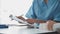 Doctor and patient sitting and talking at medical examination at hospital office, close-up. Therapist filling up medication