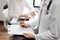 Doctor and patient view. Female physician is filling up a records from opposite a woman having a medical examination