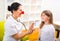 Doctor pediatrician with clown nose and happy child patient