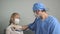 Doctor pediatrician examines child. Pediatrician applies stethoscope to child`s back, listens to the heart and lungs of