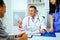 doctor physician and nurse practitioner giving nasal spray to female patient in hospital consultation