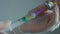 Doctor picks up a drug in a syringe
