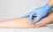 Doctor plastic surgeon examines the skin on the patient`s elbow. The concept of plastic surgery and skin tightening on the hands,