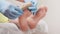 Doctor podologist in blue medical gloves remove a silicone fixator from a client's feet. Closeup. The concept of