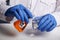 Doctor Pours Orange Poison from Flask - Labs Photo