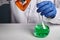 Doctor Pours Orange Toxin into Green Fluid - Labs Photo