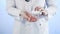 Doctor pours pills out of the bottle on a blue background